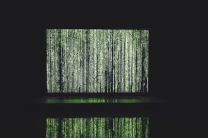 Ones and zeros green algorithm with black background to demonstrate the key role that algoritms play in the optimization of online content.