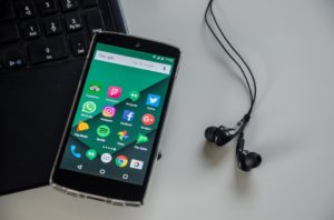 Smartphone with social media apps - the perfect way to promote having a company blog.