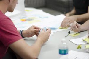 Table filled with sticky notes and paperwork - the creation of the perfect business strategy in progress.