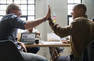 Two people high-fiving each other.