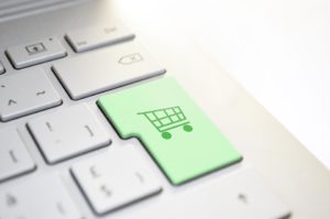 Green shopping cart button on a keyboard.