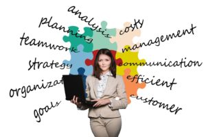 Businesswoman with a laptop, with all the benefits of ERP behind her.