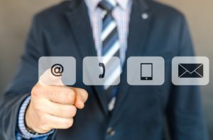Bussinesman pressing a Email icon.