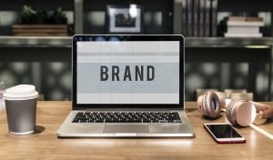 BRAND on laptop screen.