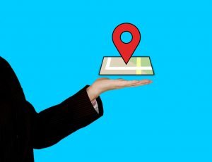 Hand hloding a phone with location tag.