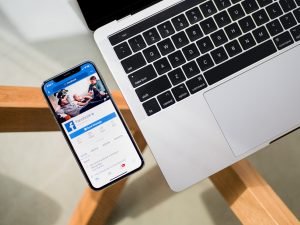 facebook page on a phone and a laptop
