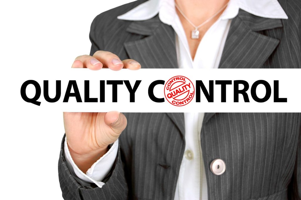 Businesswoman holding a Quality Control label