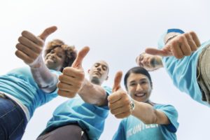 a team pointing thumbs up becuase