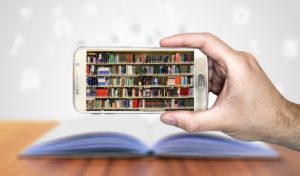 a mobile phone with a picture of a bookshelf on the screen
