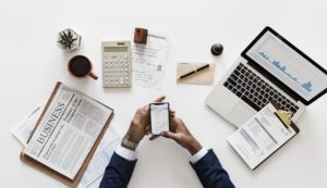 a man sitting at a desk and trying to make a decision on the investment