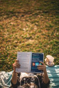 Person reading a book about digital marketing.
