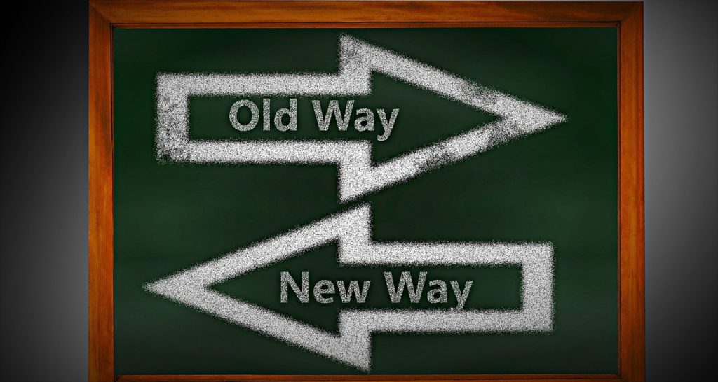 Old way arrow and New way arrow on a green board.