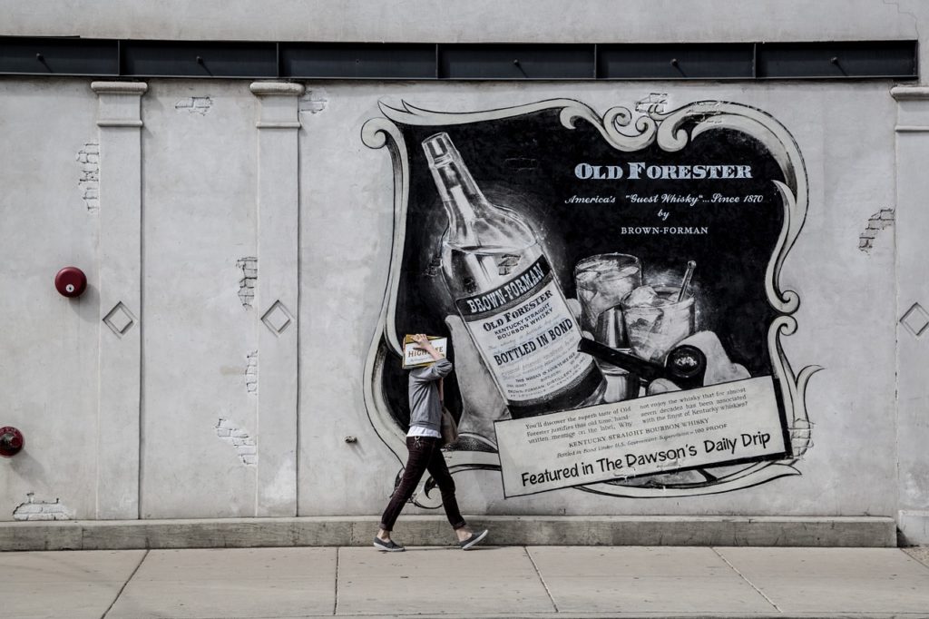 Advertisement painted on a street wall.