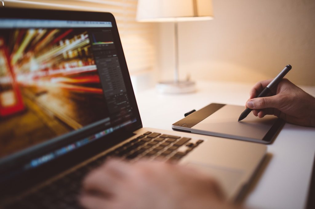 Laptop and person taking notes about the referral program