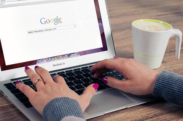 Person typing in keywords in Google search bar