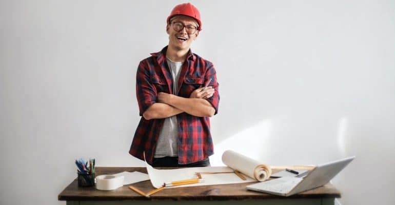An image of a contractor with plans on the table.