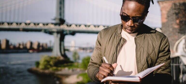 Man with a notepad, outside