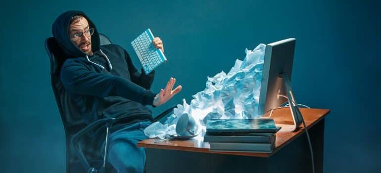 An avalanche of letters coming out of a laptop.