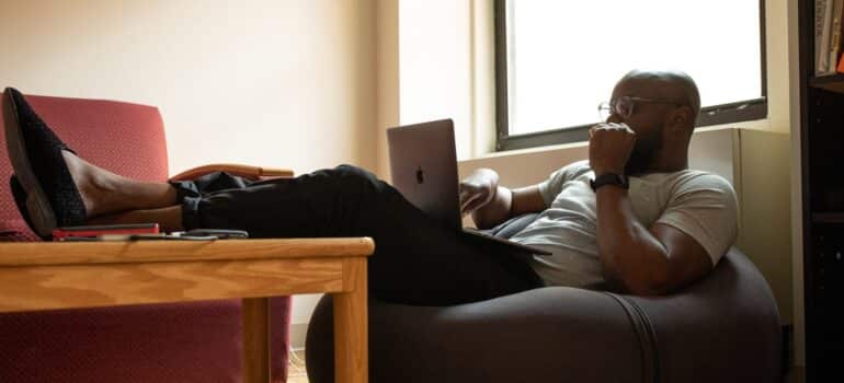 A potential client using a laptop, showing you why you need to increase user engagement.