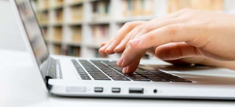 Person typing on a laptop.
