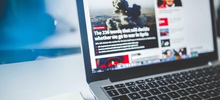 Laptop open to a news site.