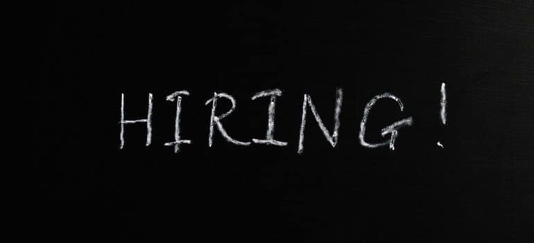 The word "hiring" on a blackboard.
