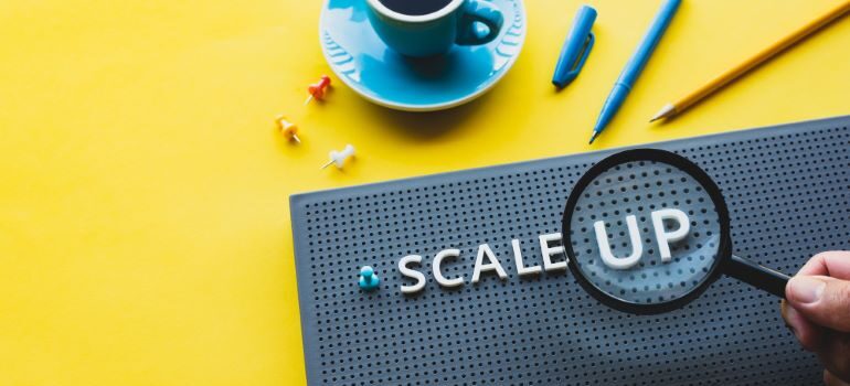 Scale Up on black grid board.