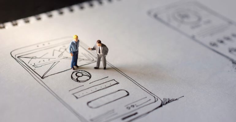 Vector image of two figurines on rough design sketch for web design.