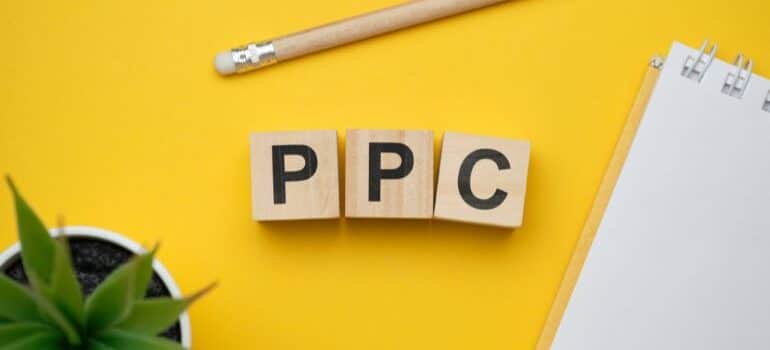 Three wooden dice spelling PPC