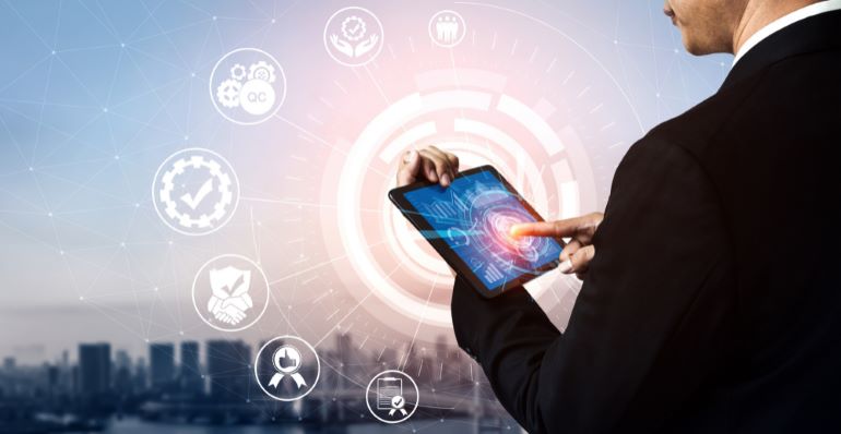 Person with a tablet, with quality management icons floating around it.