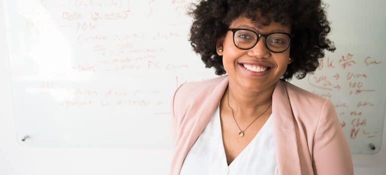 Woman standing in front of a white board.