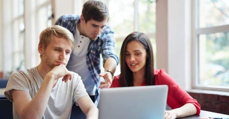 People looking at laptop.