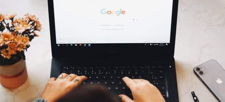 person making a google search on components of a quality moving company webpage