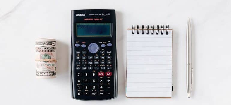 Cash, calculator, and notepad.