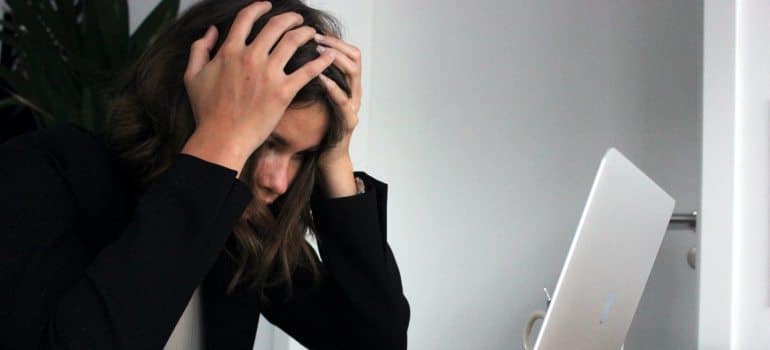 A woman thinking about ways to optimize your digital marketing ROI.