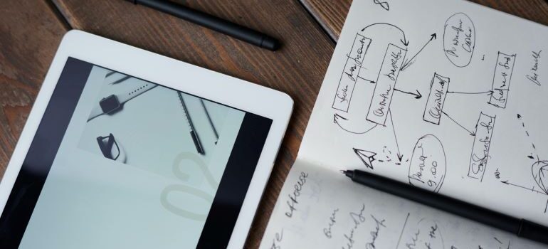 Image of notebook with notes and a tablet.