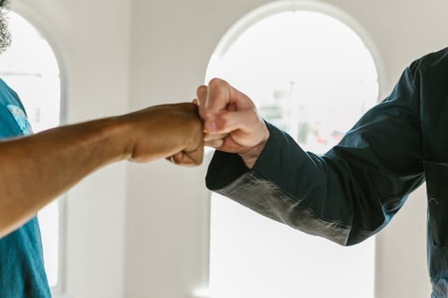 Two men bumping fists