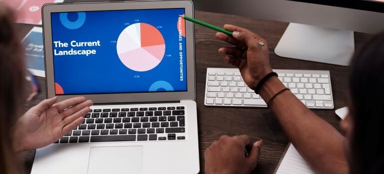 A person pointing at a laptop