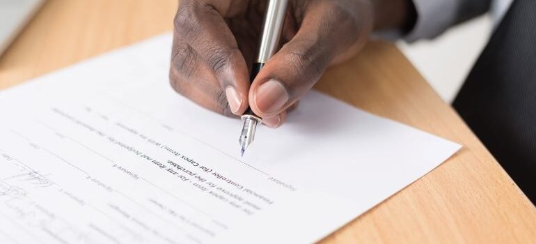 Person signing a contract.