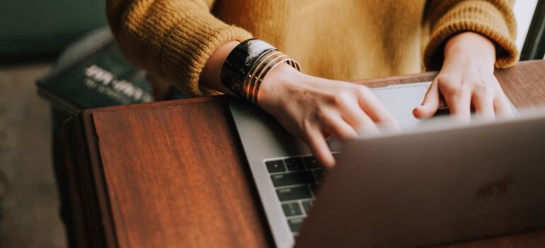 A woman typing on her laptop.