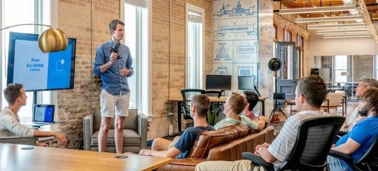 Man standing in front of a group and explaining ways for reducing moving insurance claims