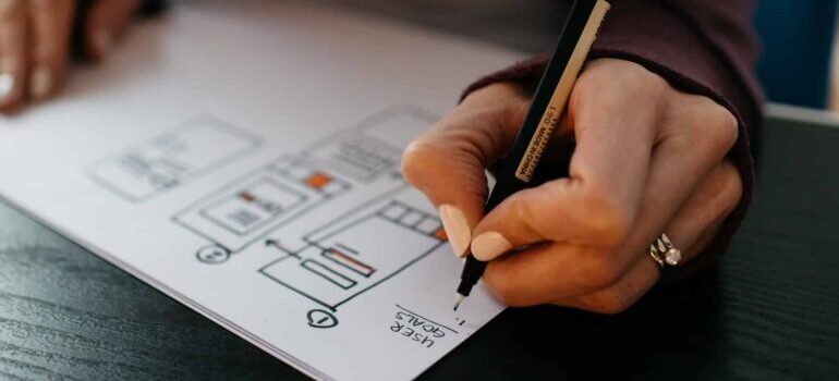 A web designer sketches out a layout for their website.