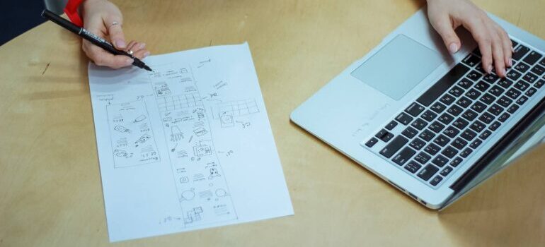 A woman using project management tools for relocation planning.