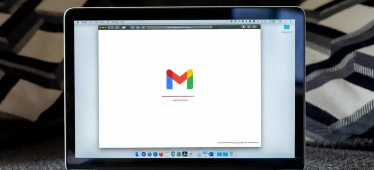 A laptop screen displaying the Gmail logo.