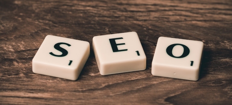 SEO written in white plastic blocks on a wooden desk