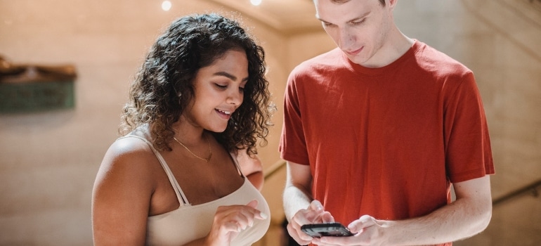 Two people standing next to each other and talking about Google continuous scrolling for moving company websites
