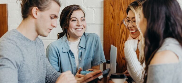 Group of people sitting at a desk and discussing how to get get customers to leave reviews