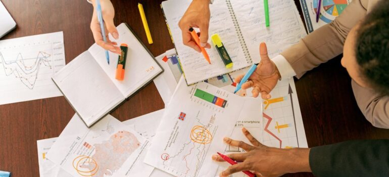 People going through papers and analyzing the benefits of referral marketing