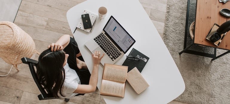 A woman using laptop to look up digital marketing guarantees that are too good to be true