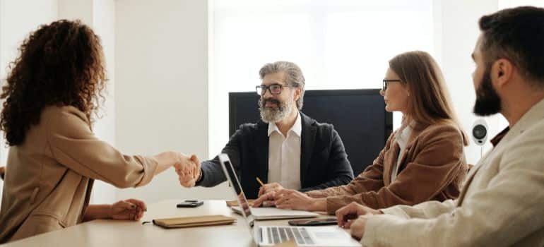 people shaking hands in a meeting